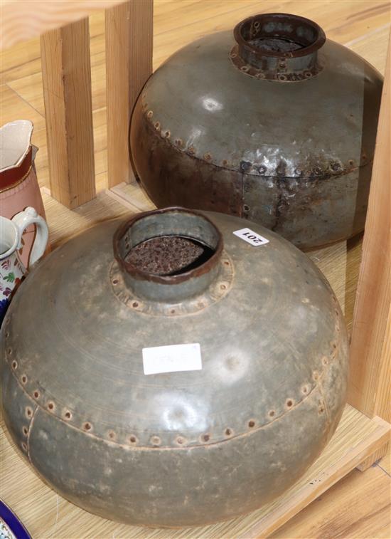 A pair of riveted beaten metal squat vases